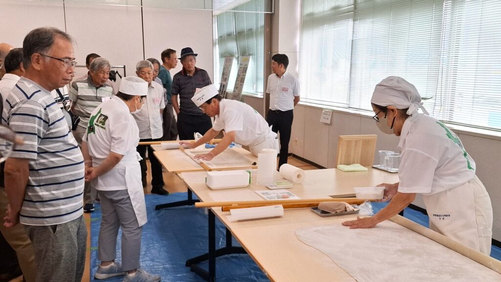 B-11.そば打ちの実演(手前の方は4段位、奥の方は5段位)